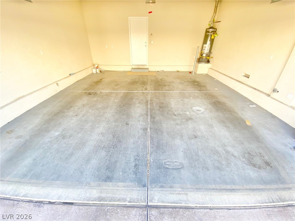 8569 Rhamus Court Las Vegas, NV 89149 - Photo 34 of 35 A spacious garage with concrete flooring provides ample storage and parking flexibility.