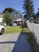 a view of a house with pool yard and a chairs
