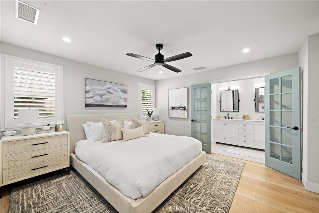 8741 La Roca Avenue Fountain Valley, CA 92708 - Photo 22 of 50 Primary suite: recessed lighting, French doors to ensuite bathroom, plantation shutters, luxury wide plank vinyl flooring