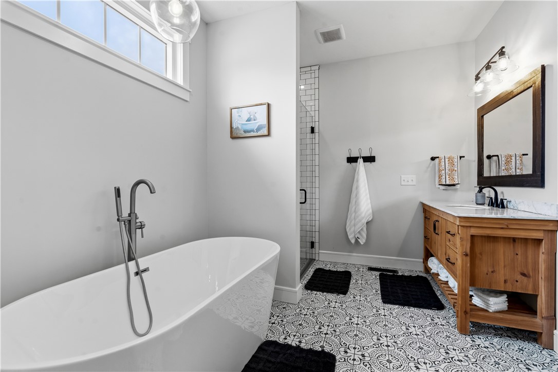 1158 Pyle Road Clarksville, OH 45113 - Photo 31 of 76 This bright bathroom features a freestanding tub and stylish dual vanities with a step in shower.