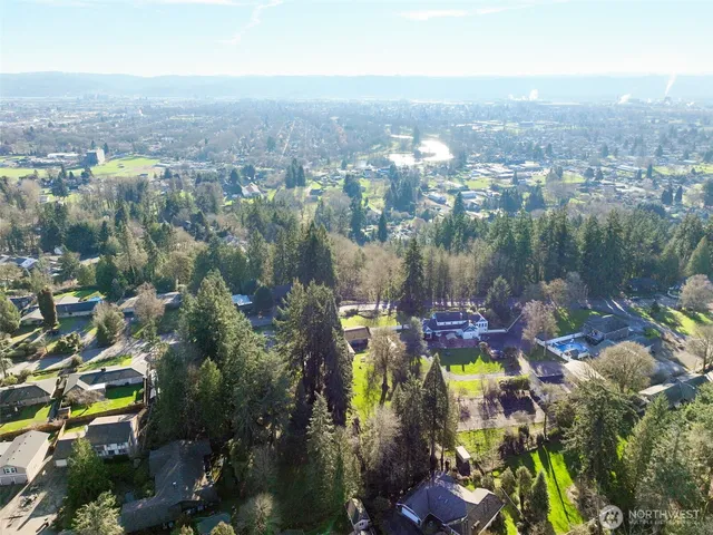 an aerial view of a residential houses with outdoor space and street view