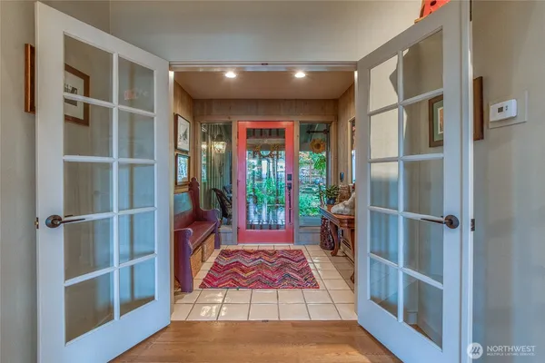 a dining room with stainless steel appliances granite countertop a table chairs and a chandelier