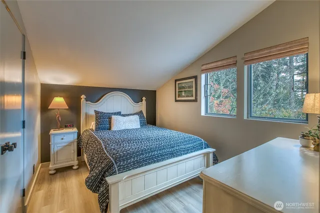 a bathroom with a toilet sink vanity and mirror