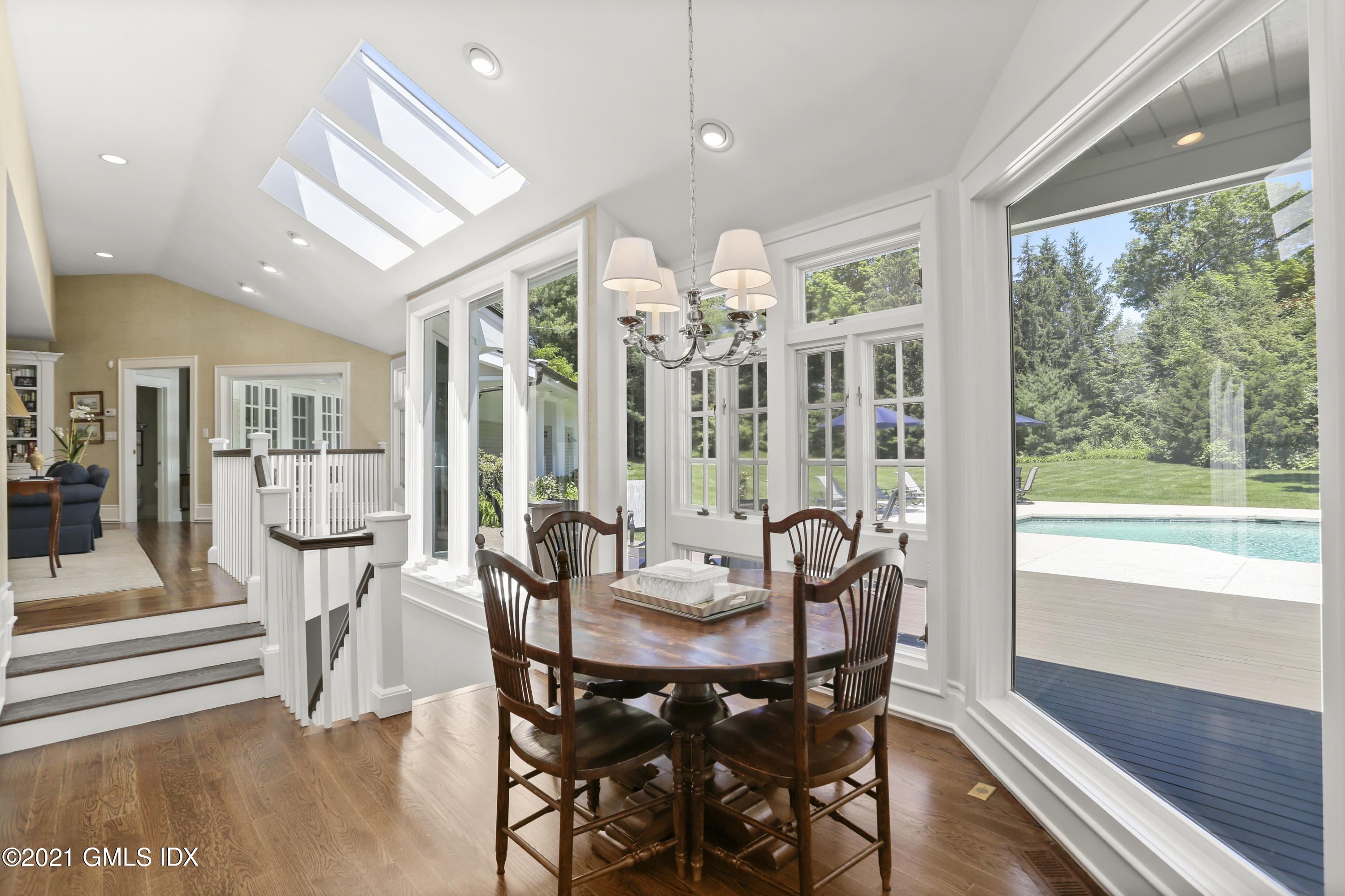 557 Round Hill Road Greenwich, CT 06831 - Photo 12 of 26 a view of a dining room with furniture large windows and wooden floor