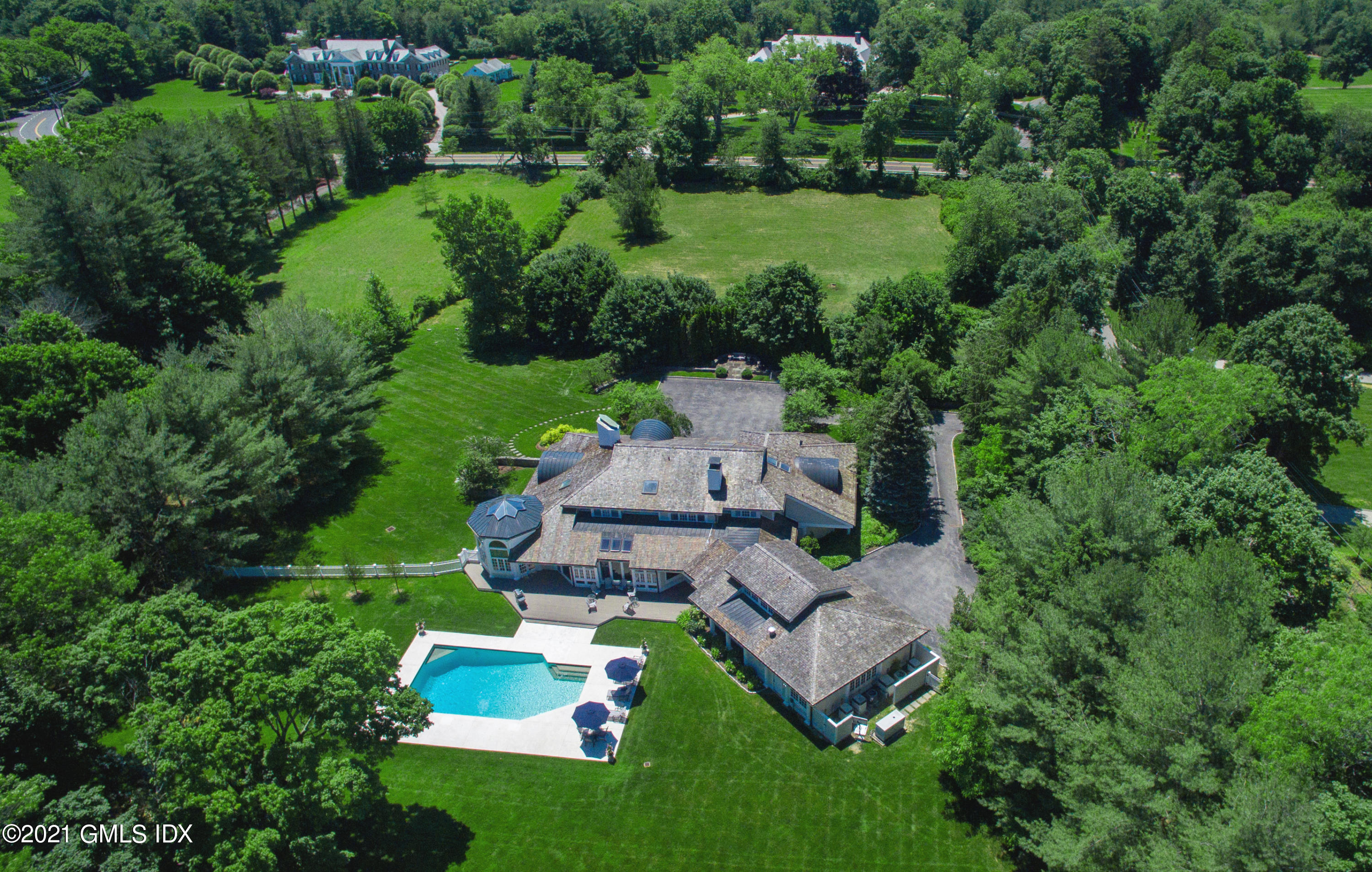 557 Round Hill Road Greenwich, CT 06831 - Photo 17 of 26 an aerial view of a house with a garden