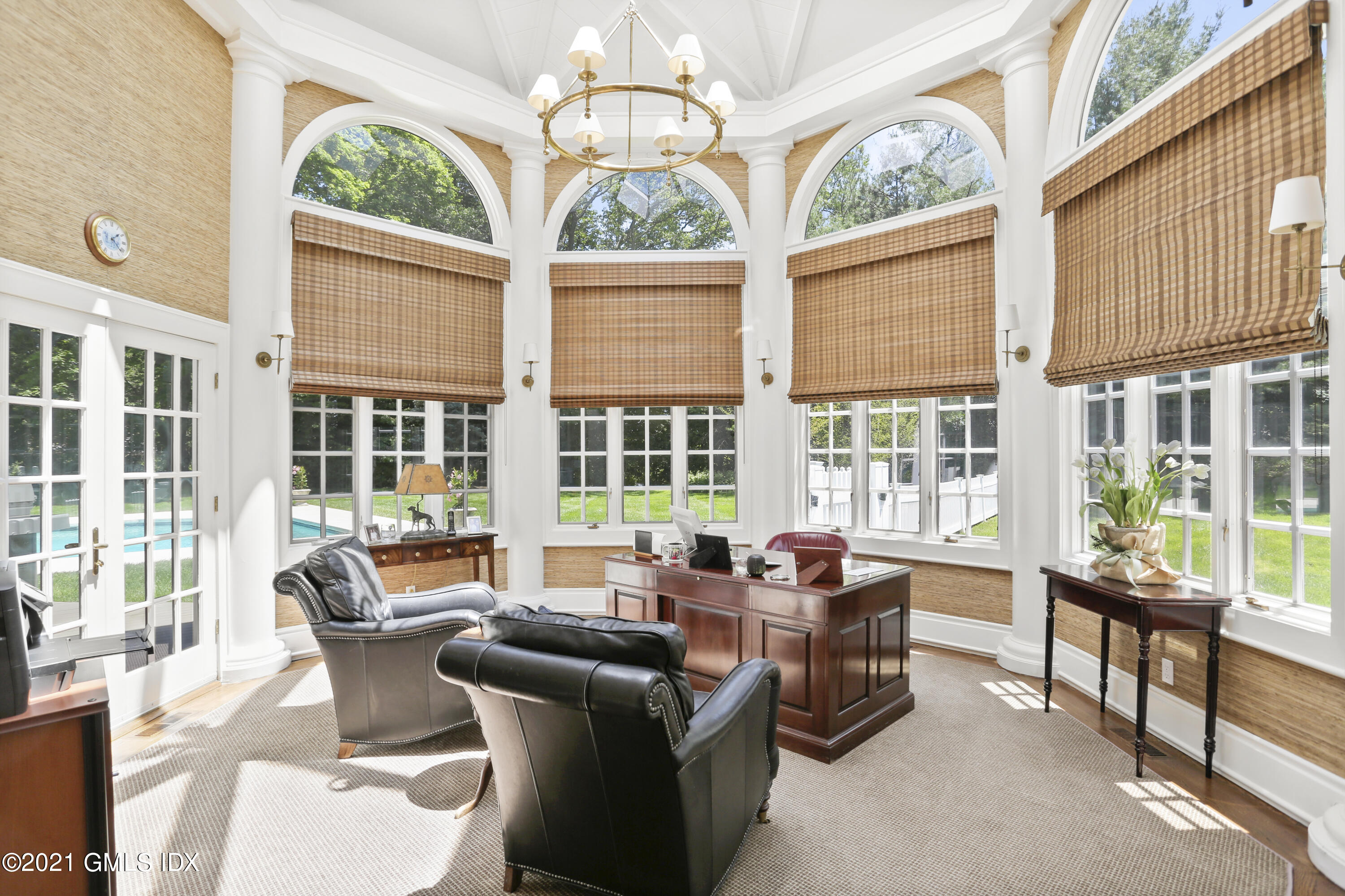 557 Round Hill Road Greenwich, CT 06831 - Photo 6 of 26 a dining room with furniture a chandelier and wooden floor