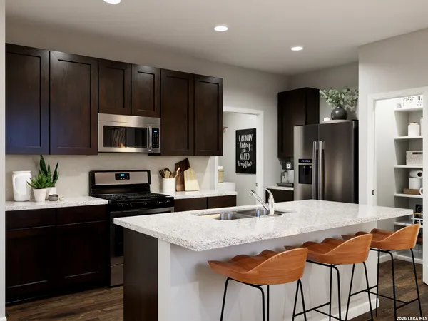 a kitchen with a table chairs sink and cabinets