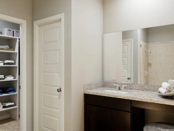 a bedroom with a bathtub and a shower