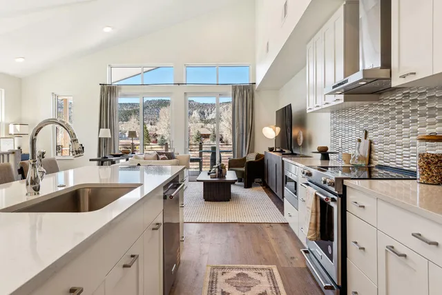 a bathroom with a double vanity sink a mirror and a bathtub
