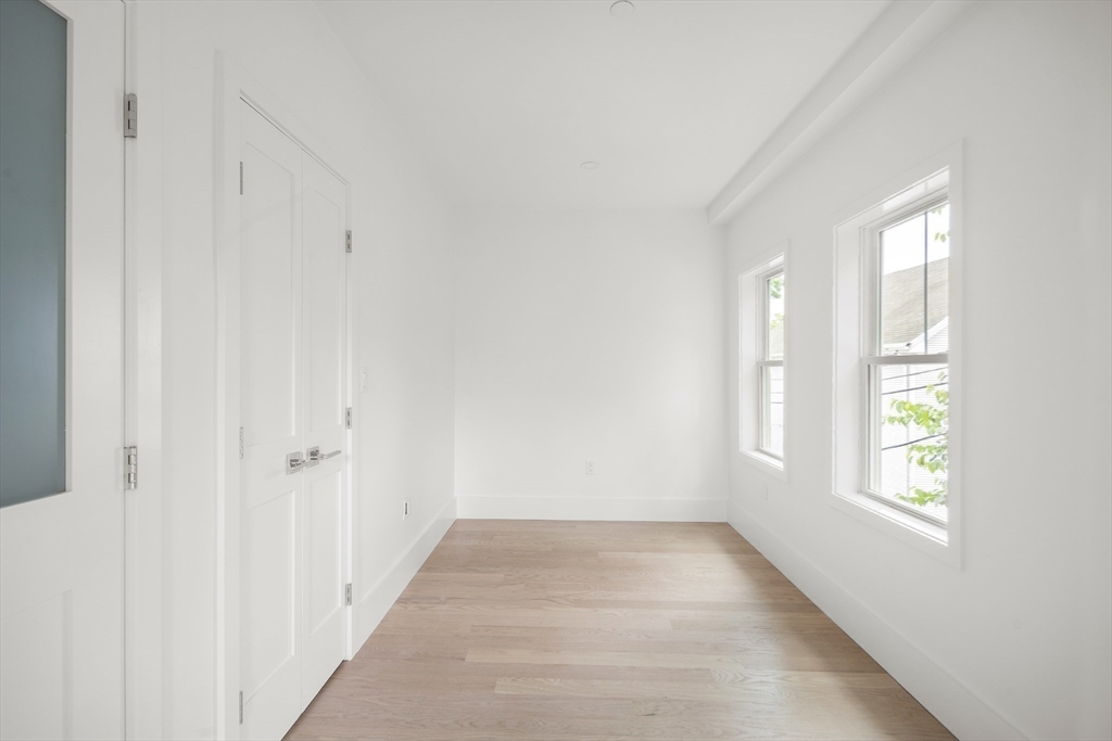 12-14 Edwin Street, Unit B Brookline, MA 02445 - Photo 11 of 18 an empty room with windows