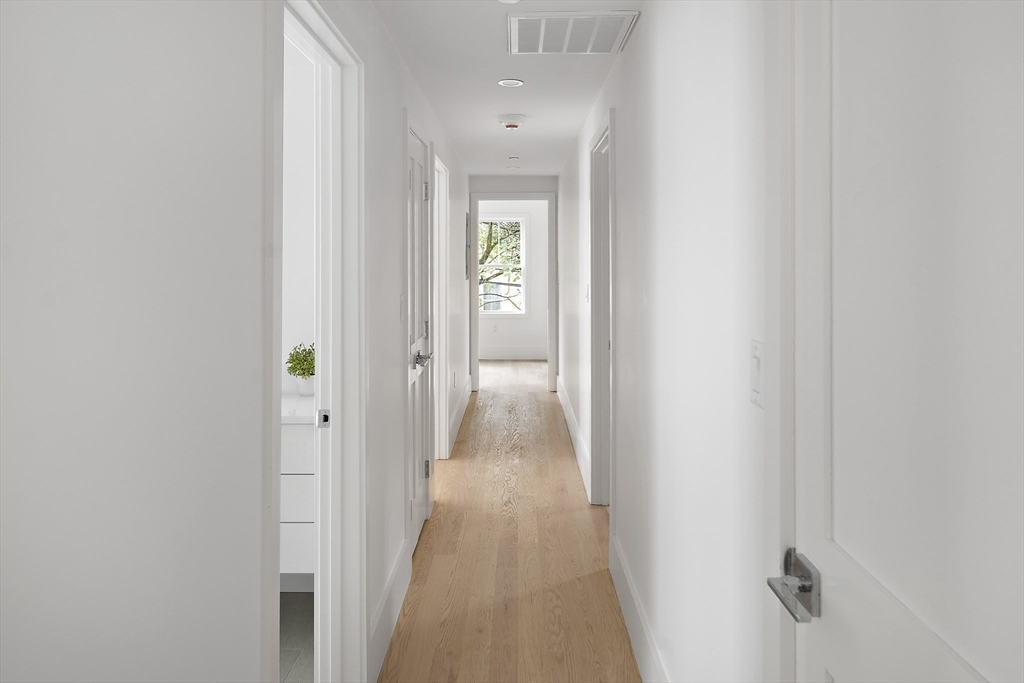 12-14 Edwin Street, Unit B Brookline, MA 02445 - Photo 13 of 18 a view of a hallway with wooden floor