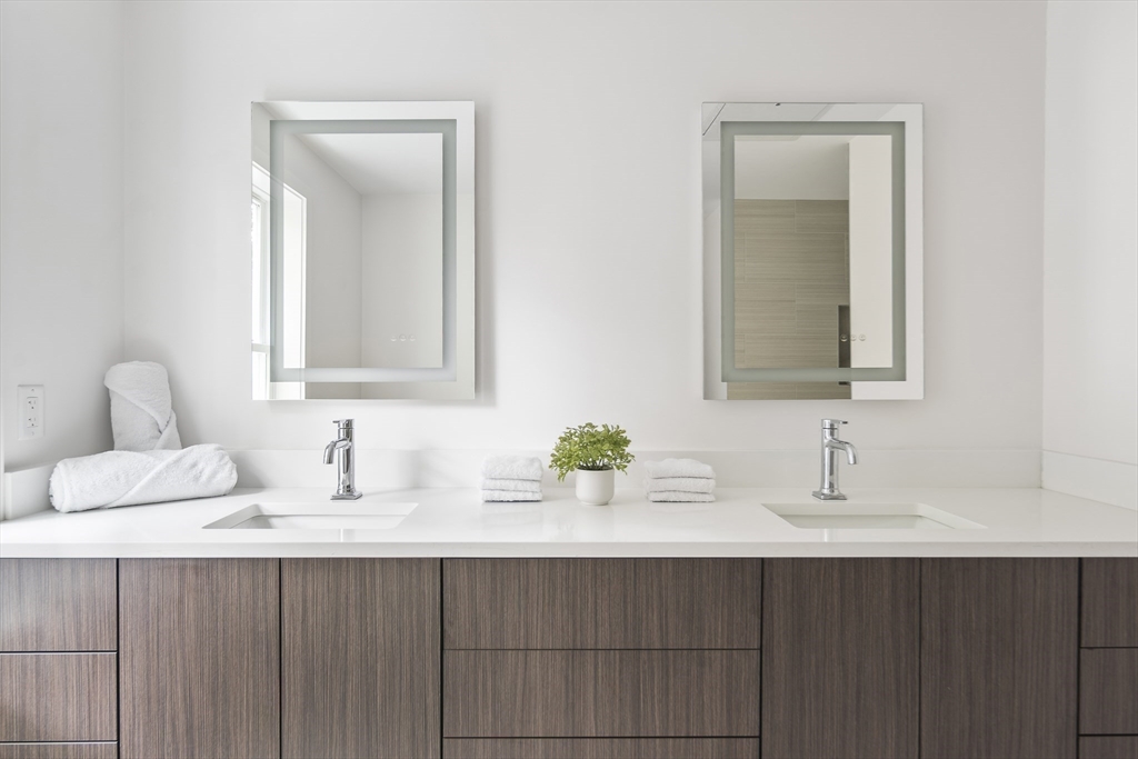 12-14 Edwin Street, Unit B Brookline, MA 02445 - Photo 15 of 18 a bathroom with a sink and a mirror