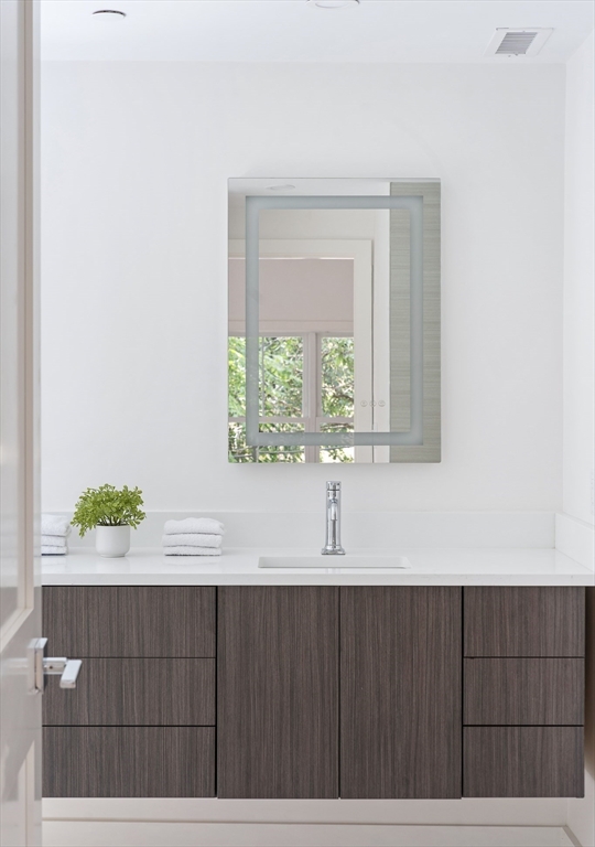 12-14 Edwin Street, Unit B Brookline, MA 02445 - Photo 16 of 18 a view of a wooden floor and a window