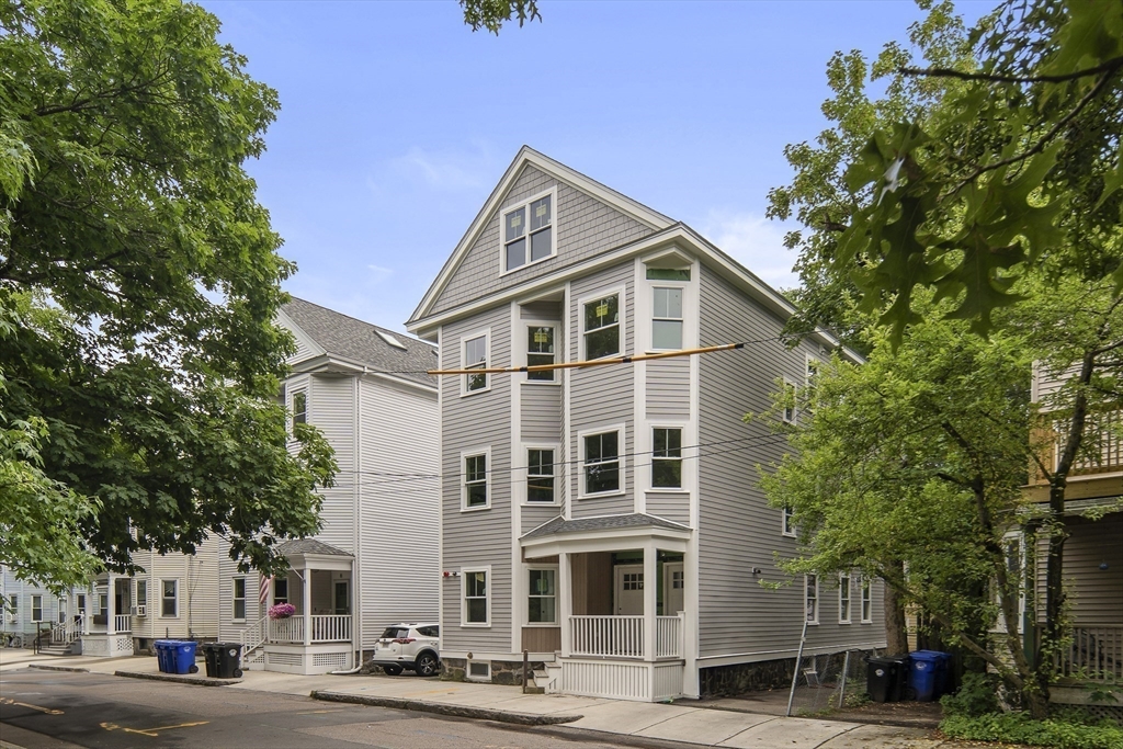 12-14 Edwin Street, Unit B Brookline, MA 02445 - Photo 17 of 18 a front view of a building with a yard