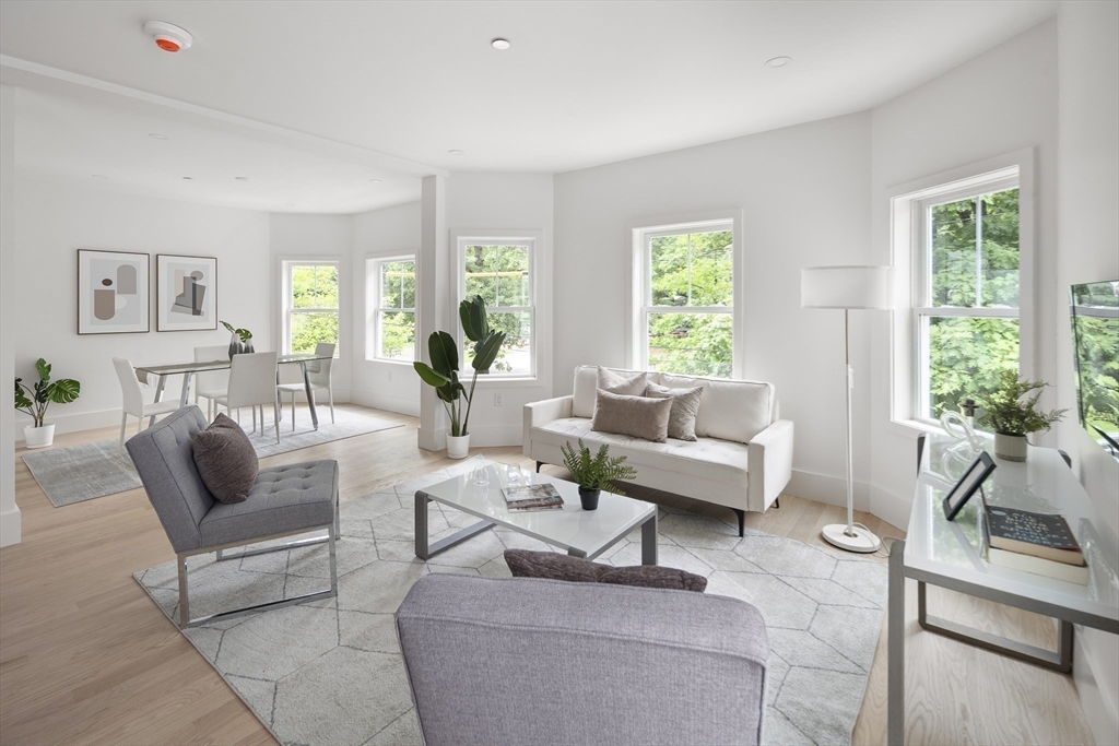 12-14 Edwin Street, Unit B Brookline, MA 02445 - Photo 2 of 18 a living room with furniture and a large window