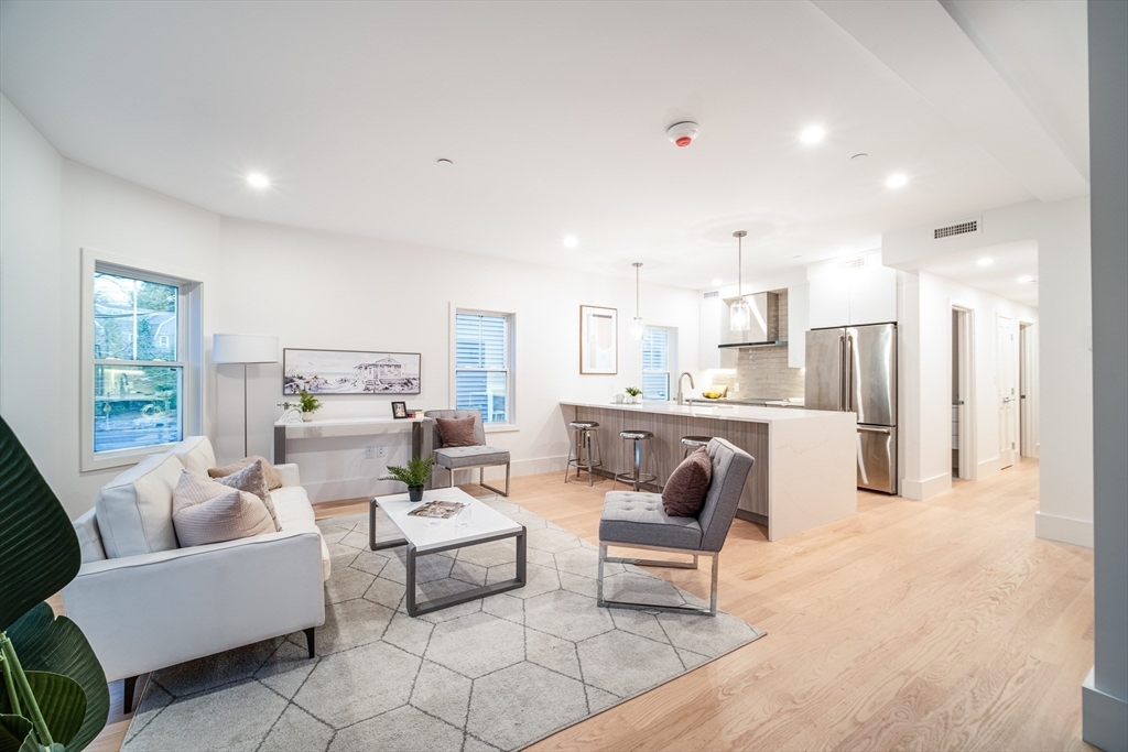 12-14 Edwin Street, Unit B Brookline, MA 02445 - Photo 3 of 18 a living room with furniture and a table