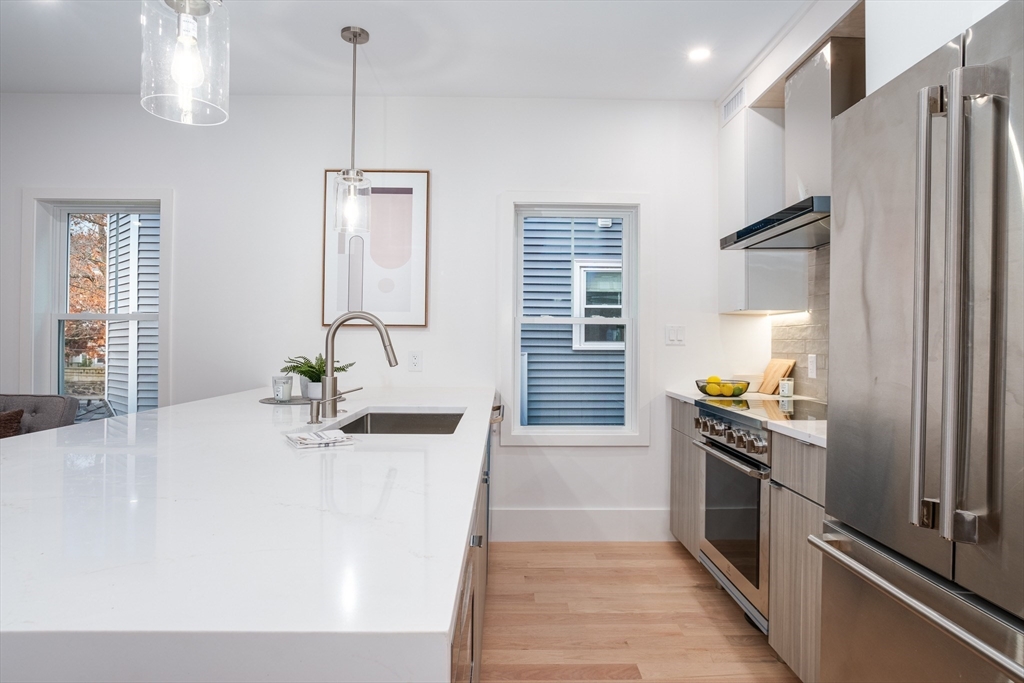 12-14 Edwin Street, Unit B Brookline, MA 02445 - Photo 6 of 18 a kitchen with stainless steel appliances a sink stove and refrigerator
