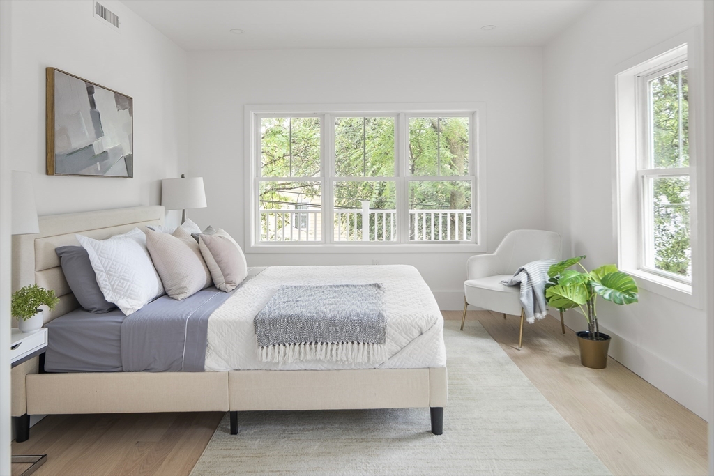 12-14 Edwin Street, Unit B Brookline, MA 02445 - Photo 8 of 18 a bedroom with a bed and a couch