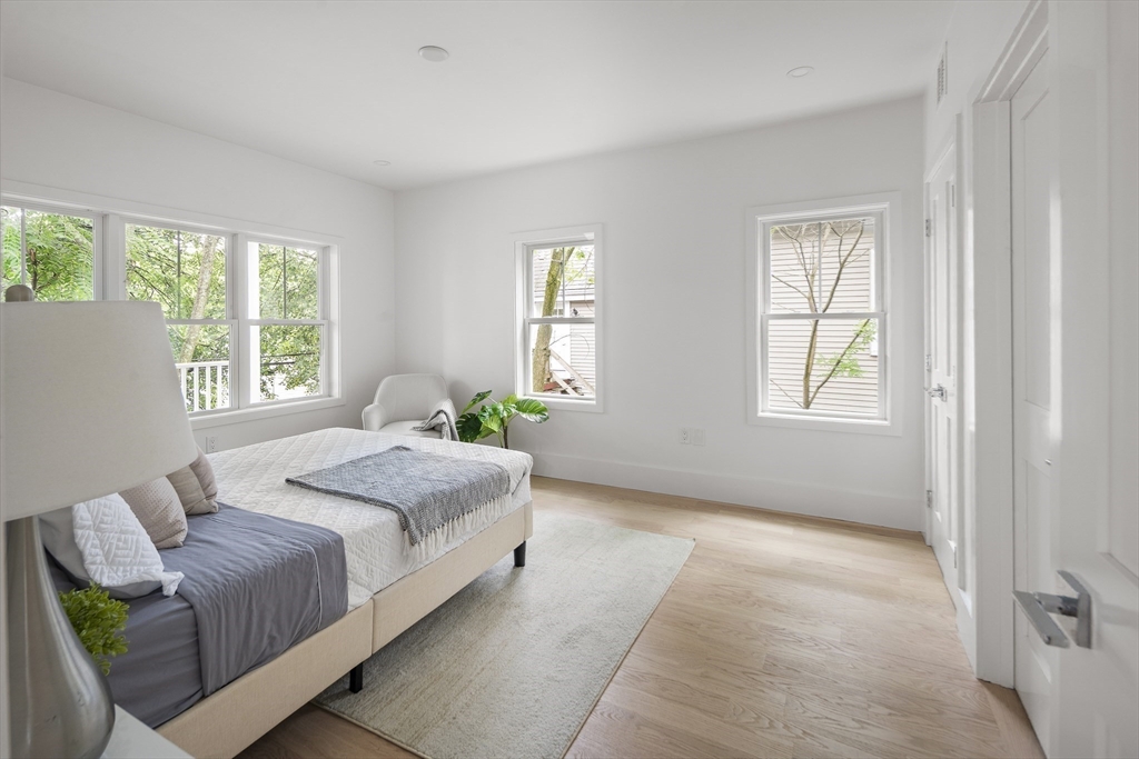 12-14 Edwin Street, Unit B Brookline, MA 02445 - Photo 9 of 18 a spacious bedroom with a bed and a window