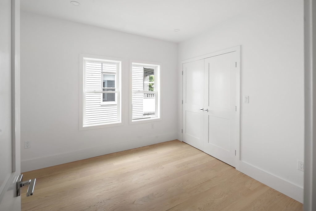 12-14 Edwin Street, Unit B Brookline, MA 02445 - Photo 10 of 18 an empty room with windows