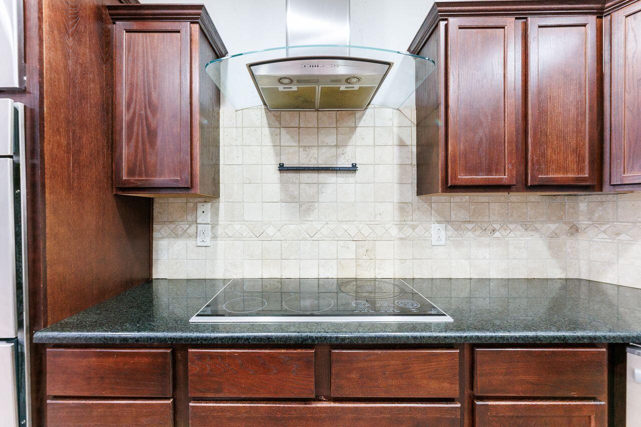 5811 11th Place, Unit 9 Lubbock, TX 79416 - Photo 14 of 50 a kitchen with granite countertop stainless steel appliances granite counter tops and a granite counter tops