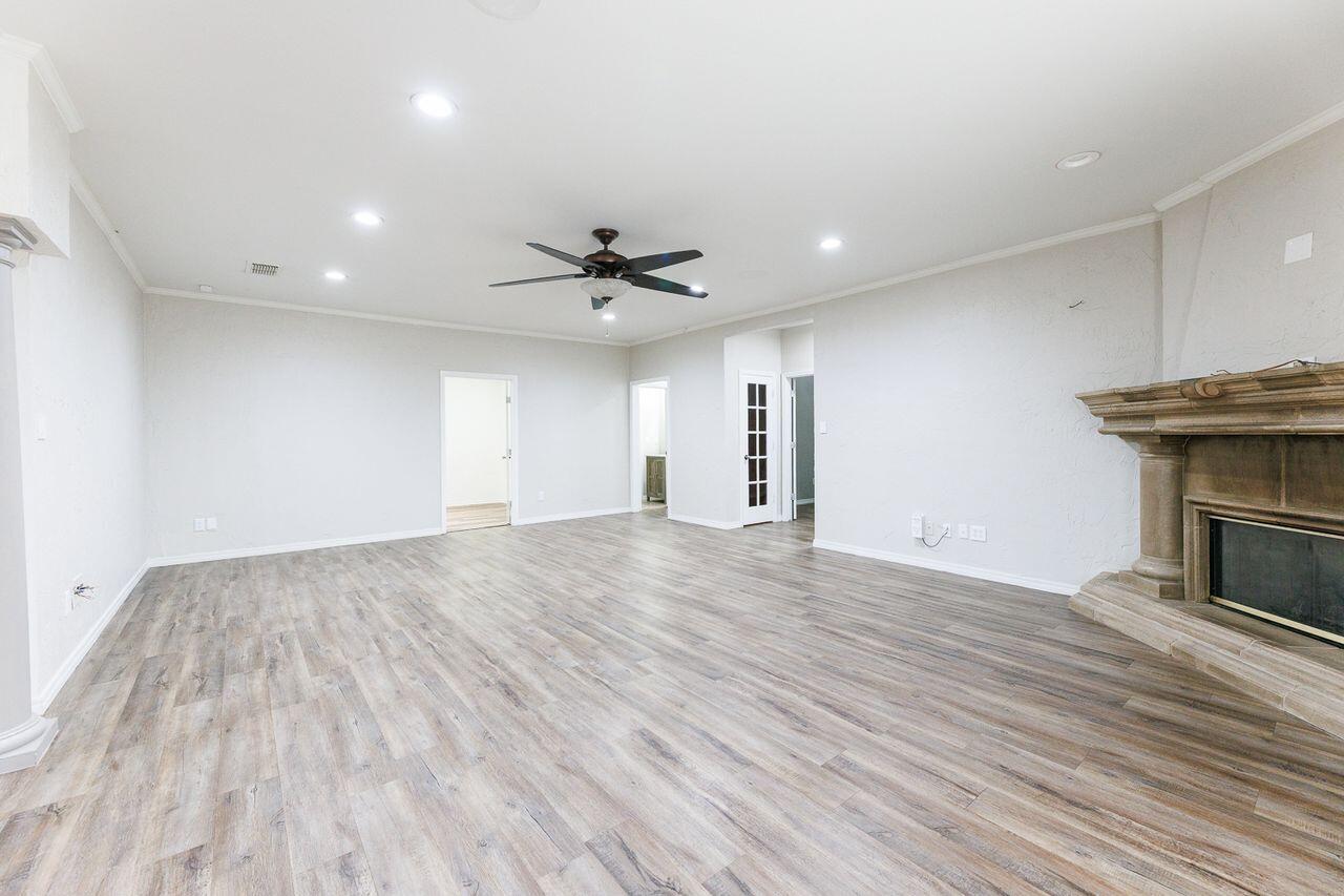 5811 11th Place, Unit 9 Lubbock, TX 79416 - Photo 24 of 50 a view of empty room with wooden floor and fan