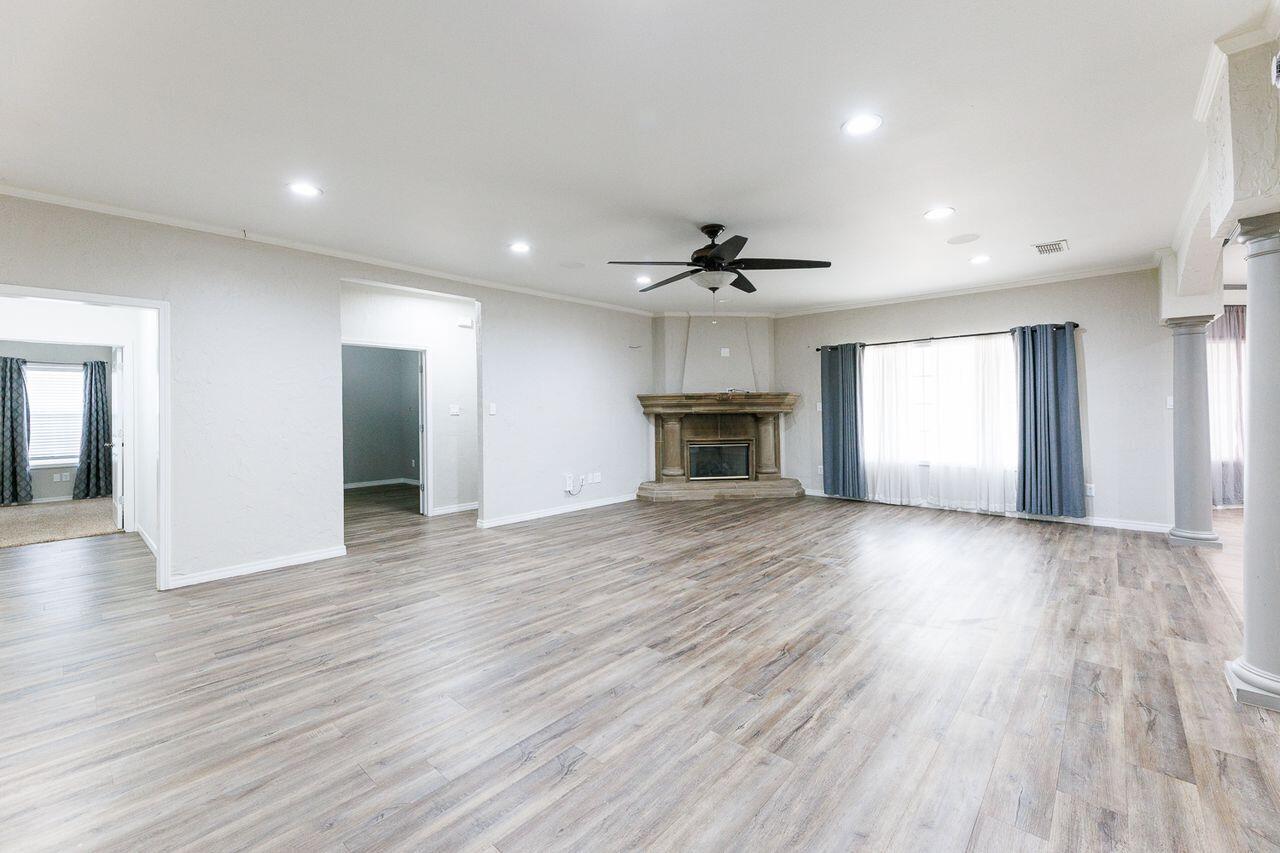 5811 11th Place, Unit 9 Lubbock, TX 79416 - Photo 25 of 50 a view of empty room with wooden floor and fireplace