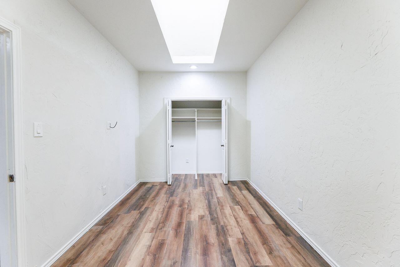 5811 11th Place, Unit 9 Lubbock, TX 79416 - Photo 28 of 50 a view of a room with wooden floor
