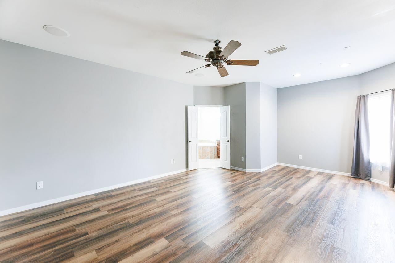 5811 11th Place, Unit 9 Lubbock, TX 79416 - Photo 34 of 50 a view of empty room with wooden floor and ceiling fan
