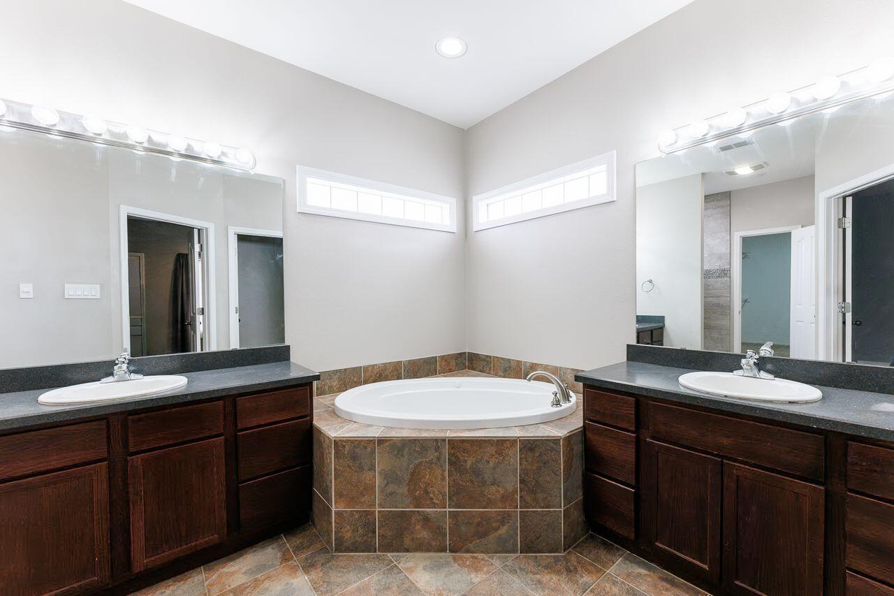 5811 11th Place, Unit 9 Lubbock, TX 79416 - Photo 37 of 50 a bathroom with a sink and a mirror