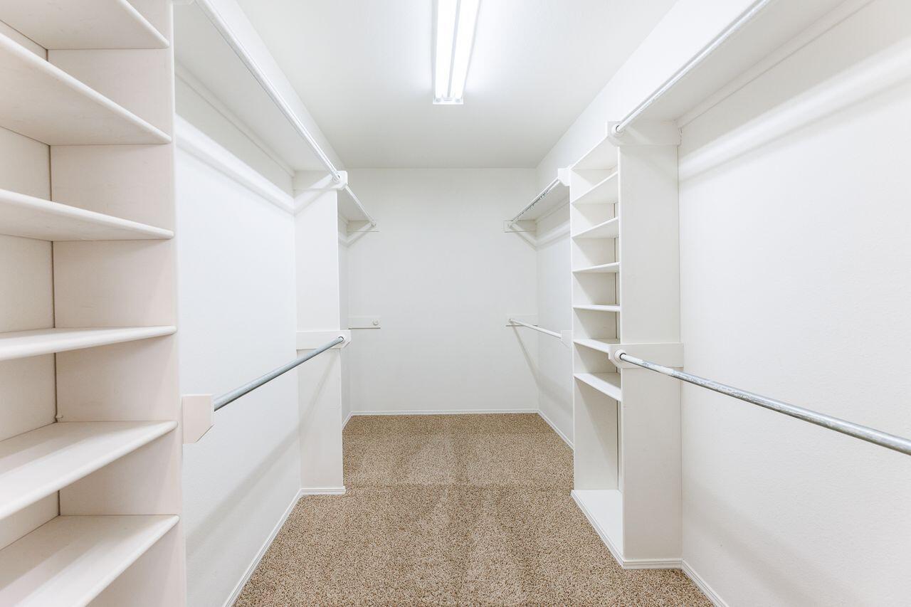 5811 11th Place, Unit 9 Lubbock, TX 79416 - Photo 42 of 50 a view of walk in closet with empty racks