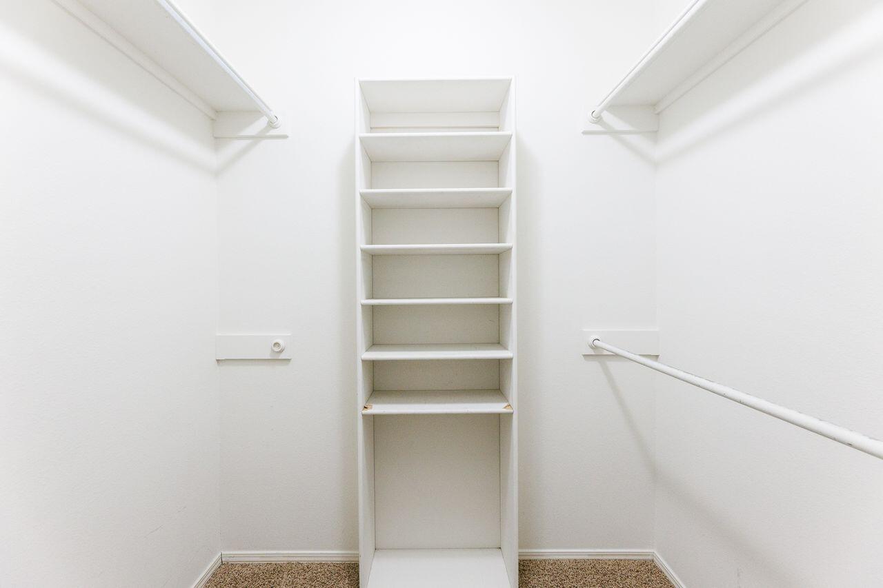5811 11th Place, Unit 9 Lubbock, TX 79416 - Photo 44 of 50 a view of walk in closet with empty racks