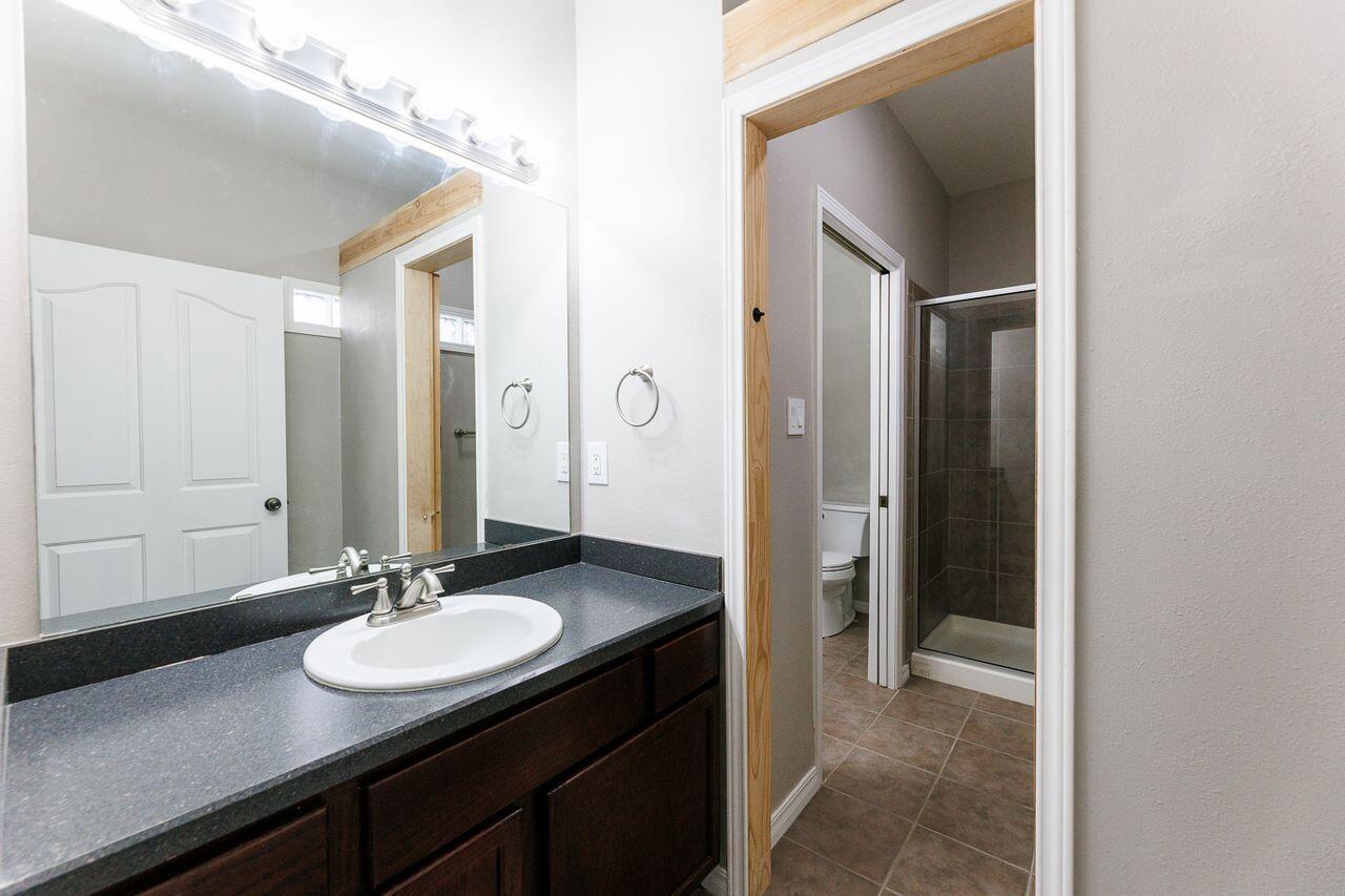 5811 11th Place, Unit 9 Lubbock, TX 79416 - Photo 46 of 50 a bathroom with a sink and a mirror