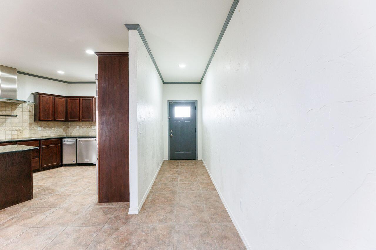 5811 11th Place, Unit 9 Lubbock, TX 79416 - Photo 6 of 50 a view of a hallway with wooden floor