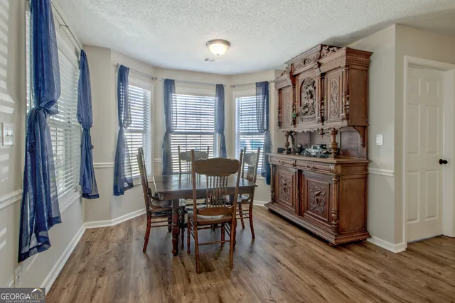 a view of a dining room with furniture and window