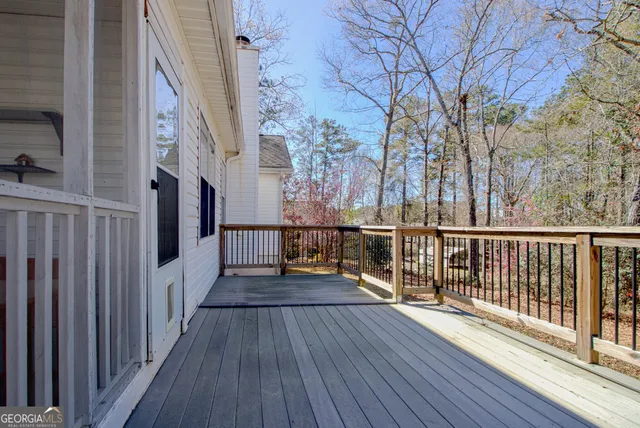 a view of a balcony with wooden floor and fence