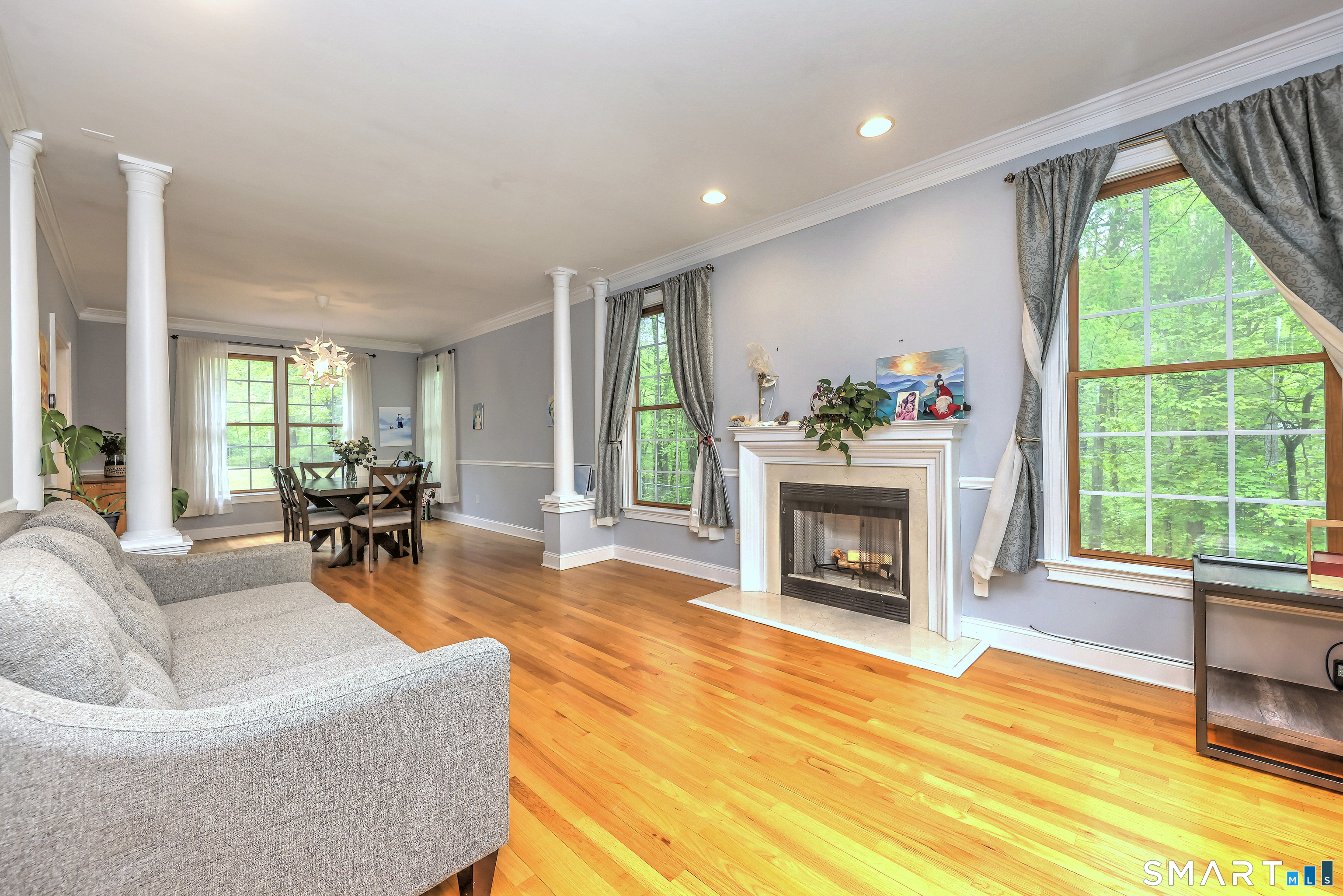 125 Peck Hill Road Woodbridge, CT 06525 - Photo 5 of 40 a living room with furniture a fireplace and a large window