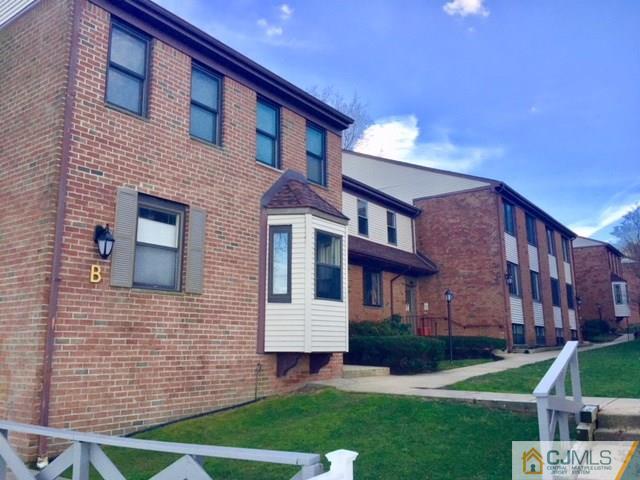 200 Portland Road, Unit 18B Highlands, NJ 07734 - Photo 2 of 18 a brick building with a yard in front of it