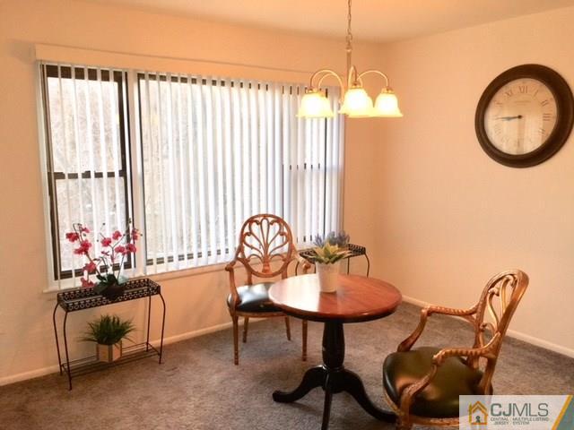 200 Portland Road, Unit 18B Highlands, NJ 07734 - Photo 5 of 18 a dining room with furniture and a chandelier