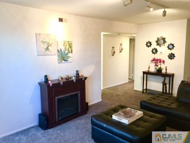 200 Portland Road, Unit 18B Highlands, NJ 07734 - Photo 7 of 18 a living room with furniture and a fireplace