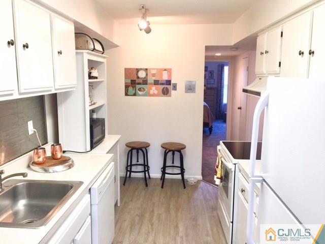 200 Portland Road, Unit 18B Highlands, NJ 07734 - Photo 8 of 18 a kitchen with stainless steel appliances kitchen island granite countertop a refrigerator and a sink