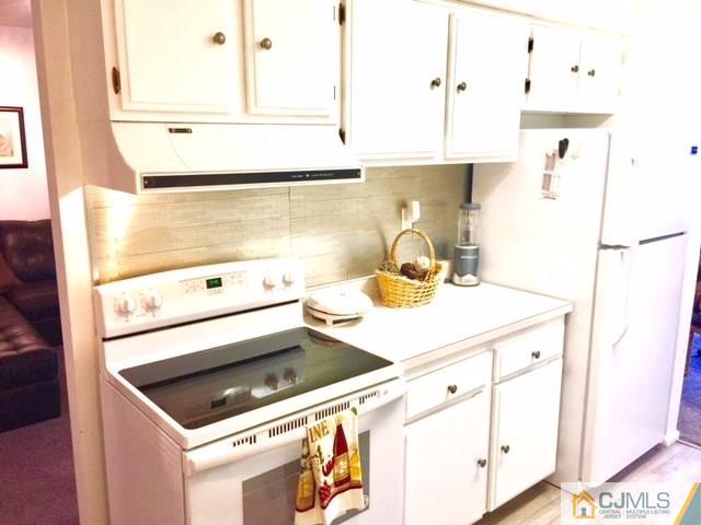200 Portland Road, Unit 18B Highlands, NJ 07734 - Photo 9 of 18 a kitchen with a sink cabinets and appliances