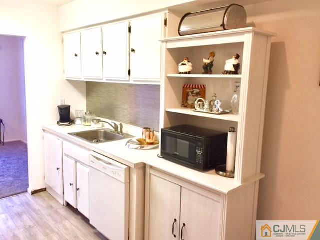 200 Portland Road, Unit 18B Highlands, NJ 07734 - Photo 10 of 18 a kitchen with stainless steel appliances granite countertop a sink a stove and cabinets