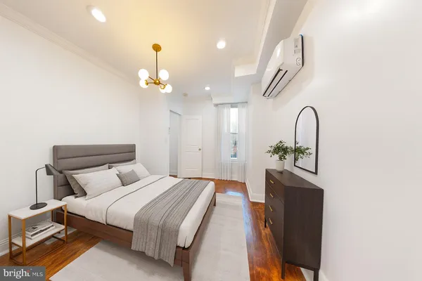 a bedroom with bed and a chandelier