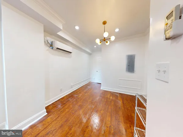 a view of empty room with wooden floor