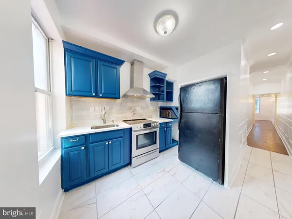 a kitchen with stainless steel appliances granite countertop a refrigerator and a sink