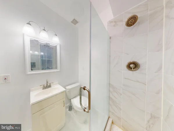 a bathroom with a sink mirror and vanity