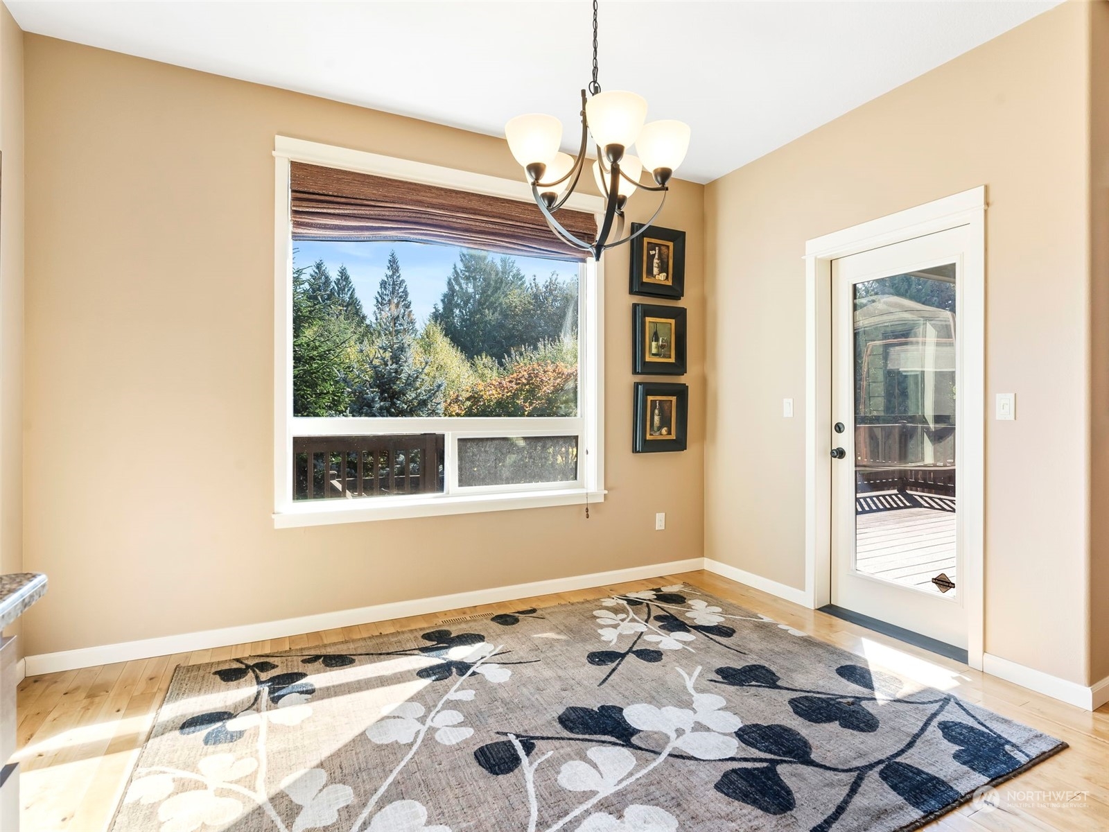 17005 Northeast 33rd Avenue Ridgefield, WA 98642 - Photo 8 of 38 a view of a livingroom with wooden floor and a chandelier