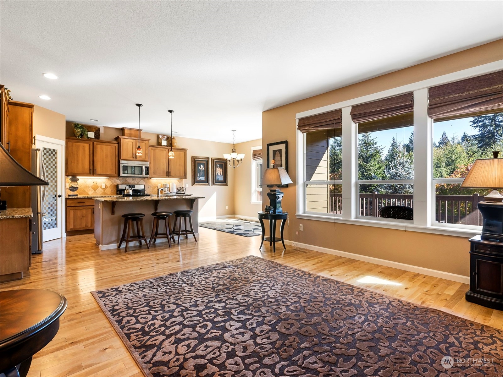 17005 Northeast 33rd Avenue Ridgefield, WA 98642 - Photo 10 of 38 a living room with fireplace furniture and a large window