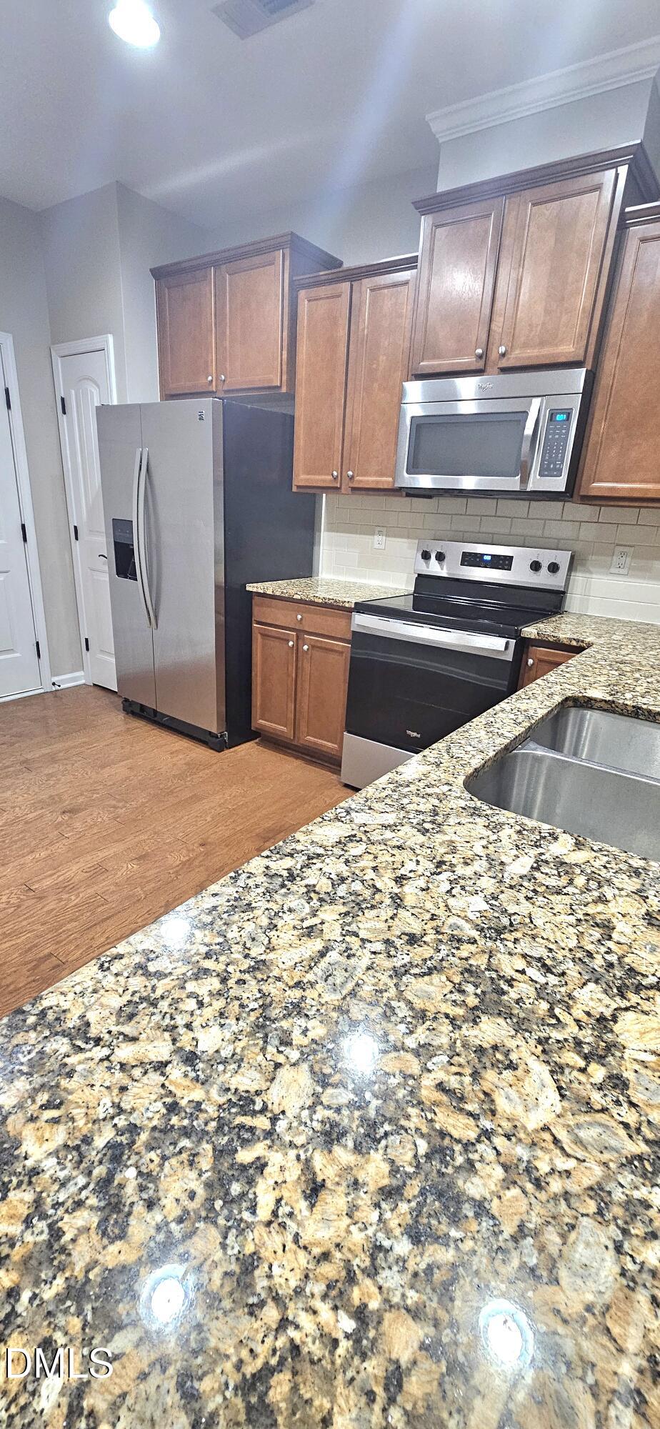 313 Brier Crossings Loop Durham, NC 27703 - Photo 12 of 27 a kitchen with a stove a sink and a refrigerator